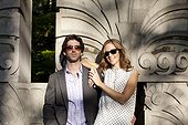 Portrait of Young Couple Standing in front of Stone Sculptures in Park, Ontario, Canada