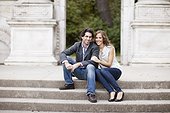 Portrait of Young Couple Sitting on Stairs in Park, Ontario, Canada