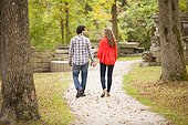 Backview of Young Couple Walking through Park in Autumn, Ontario, Canada