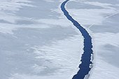 Elevated view of a large crack in pack ice at Snow Hill Island on the Weddel Sea on a sunny day at the Antarctic Peninsula, Antarctica