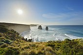 Scenic view of the limestone stacks of the Twelve Apostles backlit by the sun along the Great Ocean Road at Princeton in Victoria, Australia