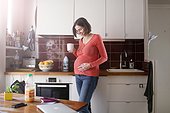 A pregnant woman at home
