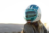 Portrait of young woman in motorcycle helmet