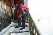 mountaineer returning to the cabin in the swizz alpes, been on a hike/ climp in winter time, snowy sorroundings