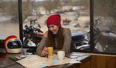 Young woman planning a motorcycle road trip