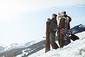 young people with snowboards on winter holiday in switzerland, enjoying the view