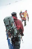 3 mountaineers in the swizz alpes, rear view, on a hike/ climb in wintertime, snowy sorroundings