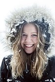 portrait of young woman in the snow, on winter holiday