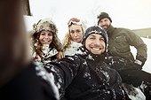 group of young people taking a selfie, in the snow, on winter holiday in switzerland,
