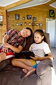 Maori children at home with tablet device