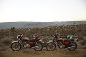 Two motorcycles parked in empty desert landscape