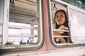 Woman travels by bus, looks out window