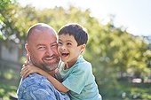 Portrait happy father holding cute son with Down Syndrome