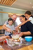 Happy family baking together in kitchen at home