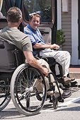 Men with spinal cord injuries exiting accessible van