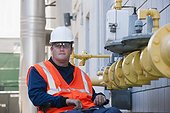 Facilities engineer in a wheelchair inspecting gas pipeline