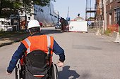 Transportation engineer in wheelchair at navy shipyard drydock