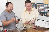 Engineering students using oscilloscope and function generator
