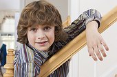 Portrait of a boy leaning on a stairway