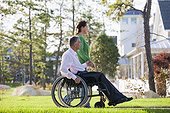 Couple looking at their neighborhood while he is in a wheelchair with a spinal cord injury