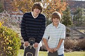 Two brothers standing with skateboards