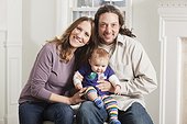 Portrait of a happy couple with their baby at home