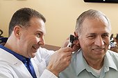 Audiologist doing an ear canal inspection of a patient