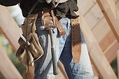 Carpenter with tool belt on a construction site