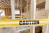 Caution tape around opening in floor on house under construction