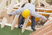 Carpenter lifting rafter for dormer