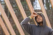 Carpenter reviewing work on house construction