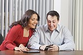 Business couple using tablet and smartphone