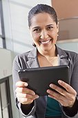 Portrait of businesswoman smiling with a tablet