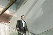 Businessman standing on the stairwell of an office building