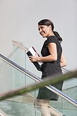 Businesswoman going up stairs of office building