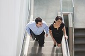 Business couple going up stairs of office building
