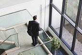 Businessman with briefcase on stairs of office building