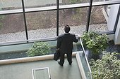 Businessman with briefcase in atrium of office building