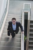 Businessman with briefcase on stairs of office building