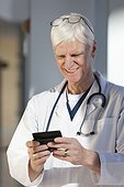 Doctor text messaging on his smartphone