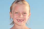 Girl with missing tooth smiling