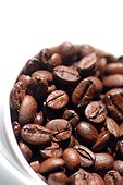 Close-up of a coffee cup with coffee beans