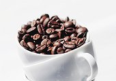 Close-up of a coffee cup with coffee beans