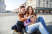 Mid adult couple on a city break using smart phone