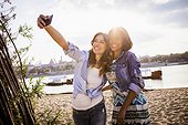 Woman and girlfriend taking a selfie with smartphone