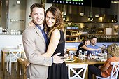 Happy couple embracing in restaurant