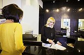 Customer and receptionist in hair salon