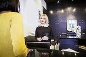 Customer and receptionist in hair salon