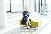Female architect using digital tablet in modern office