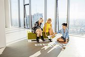 Three female architects in business meeting against urban skyline